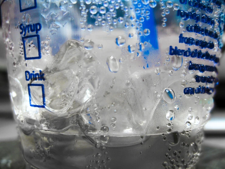 a bottled beverage bottle that is covered in water