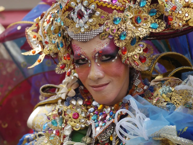 the lady is wearing very elaborate head gear and has some pretty accessories