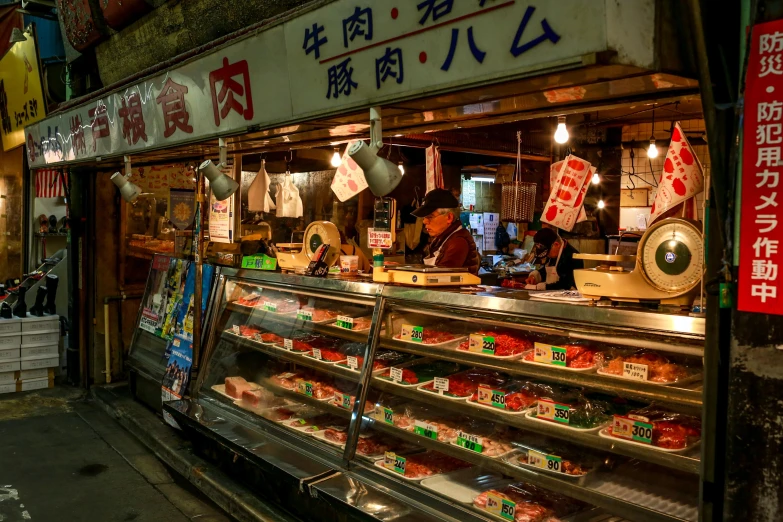 a woman standing in front of a food stand