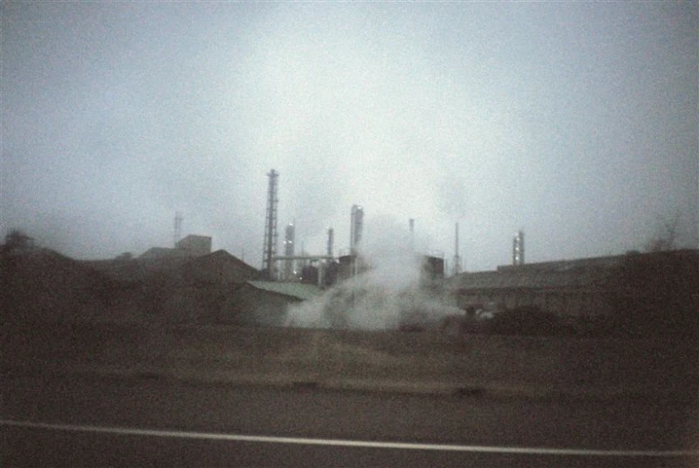 a factory spewing out smoke into the air