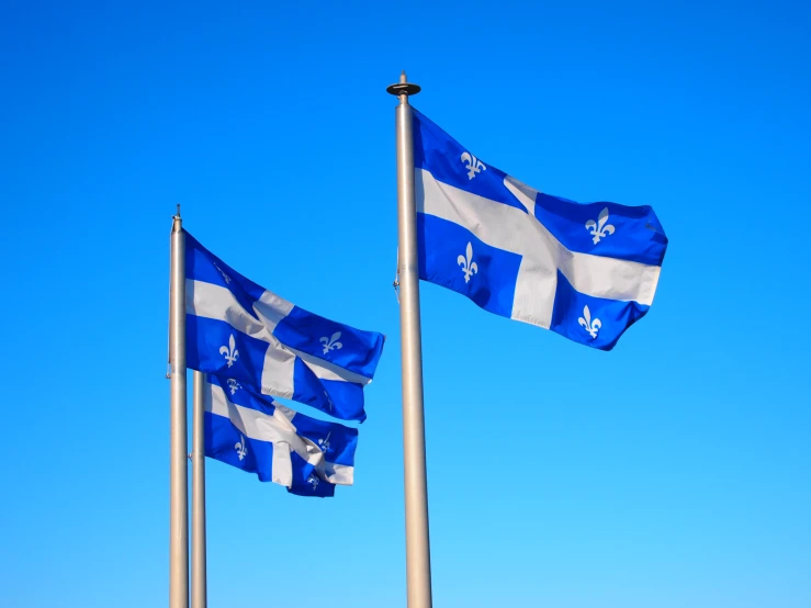 the three blue and white flags are near each other