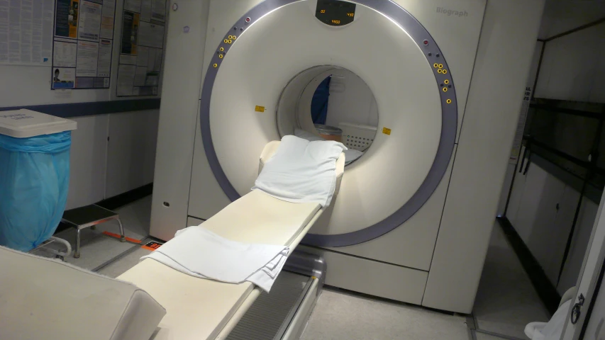 a medical equipment sits on a counter next to a large bed