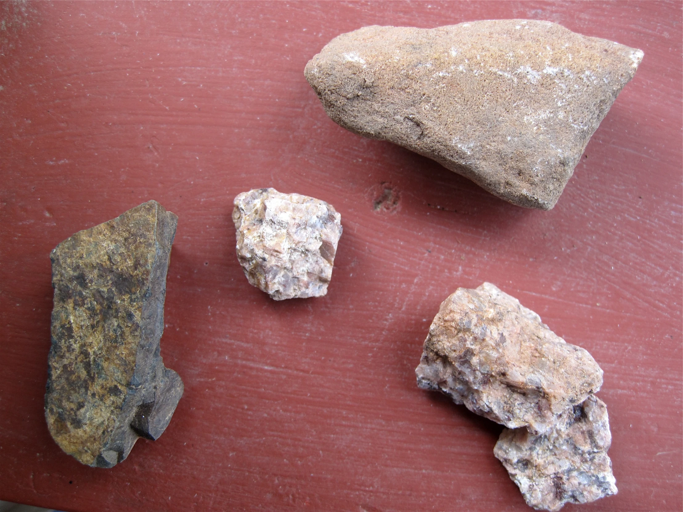 three rocks on a surface next to each other