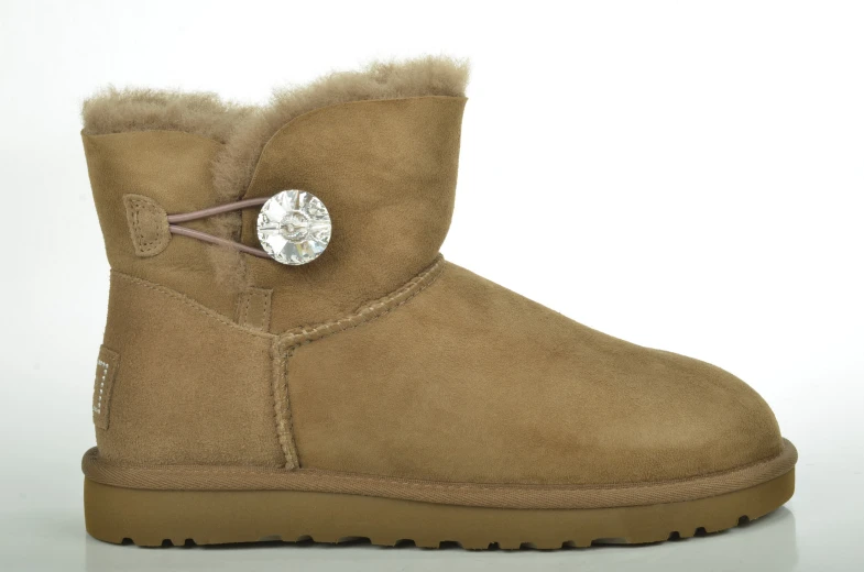 the side view of brown ugg boots with the small silver heart on