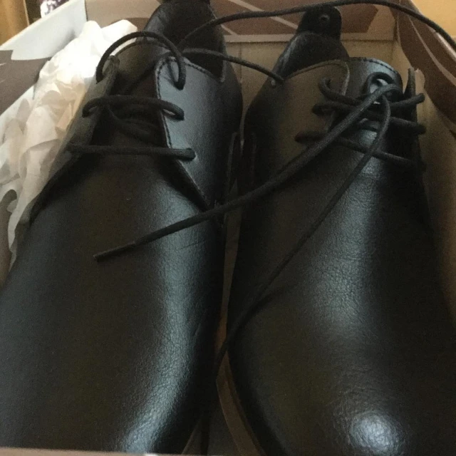 a box filled with a pair of black shoes and tissue paper