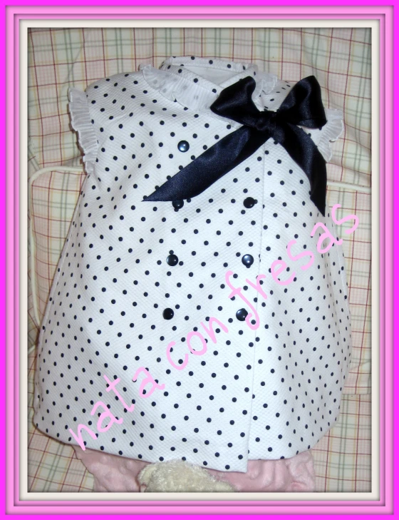 a small polka dot bag that has a bow in it