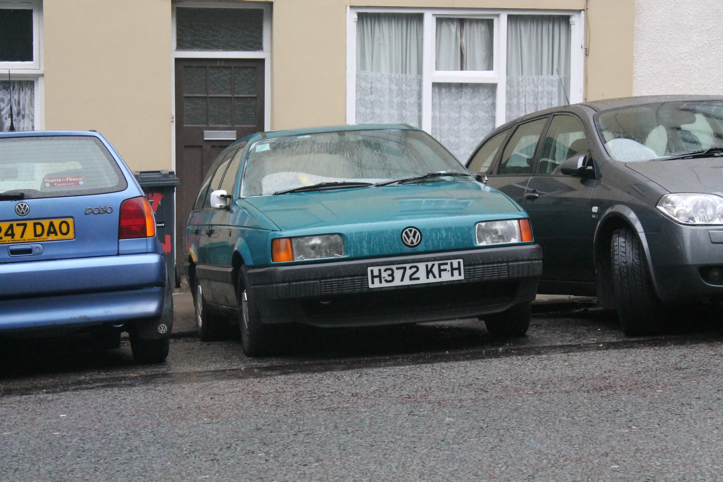 a couple of cars parked in front of a house