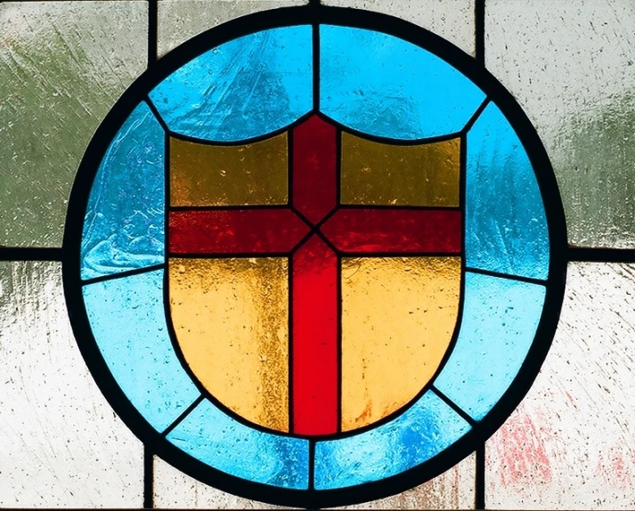 a stained glass window depicting a cross in yellow and red
