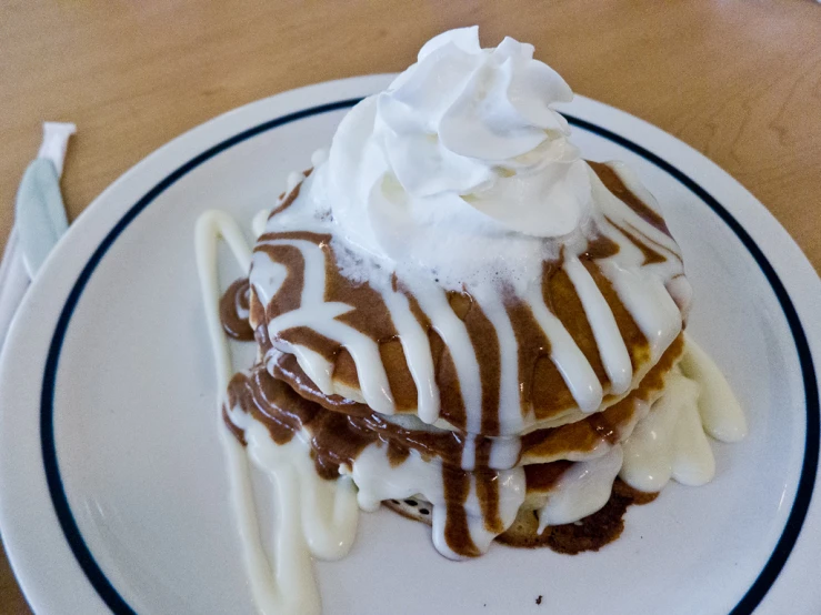 a plate topped with desert covered in whipped cream