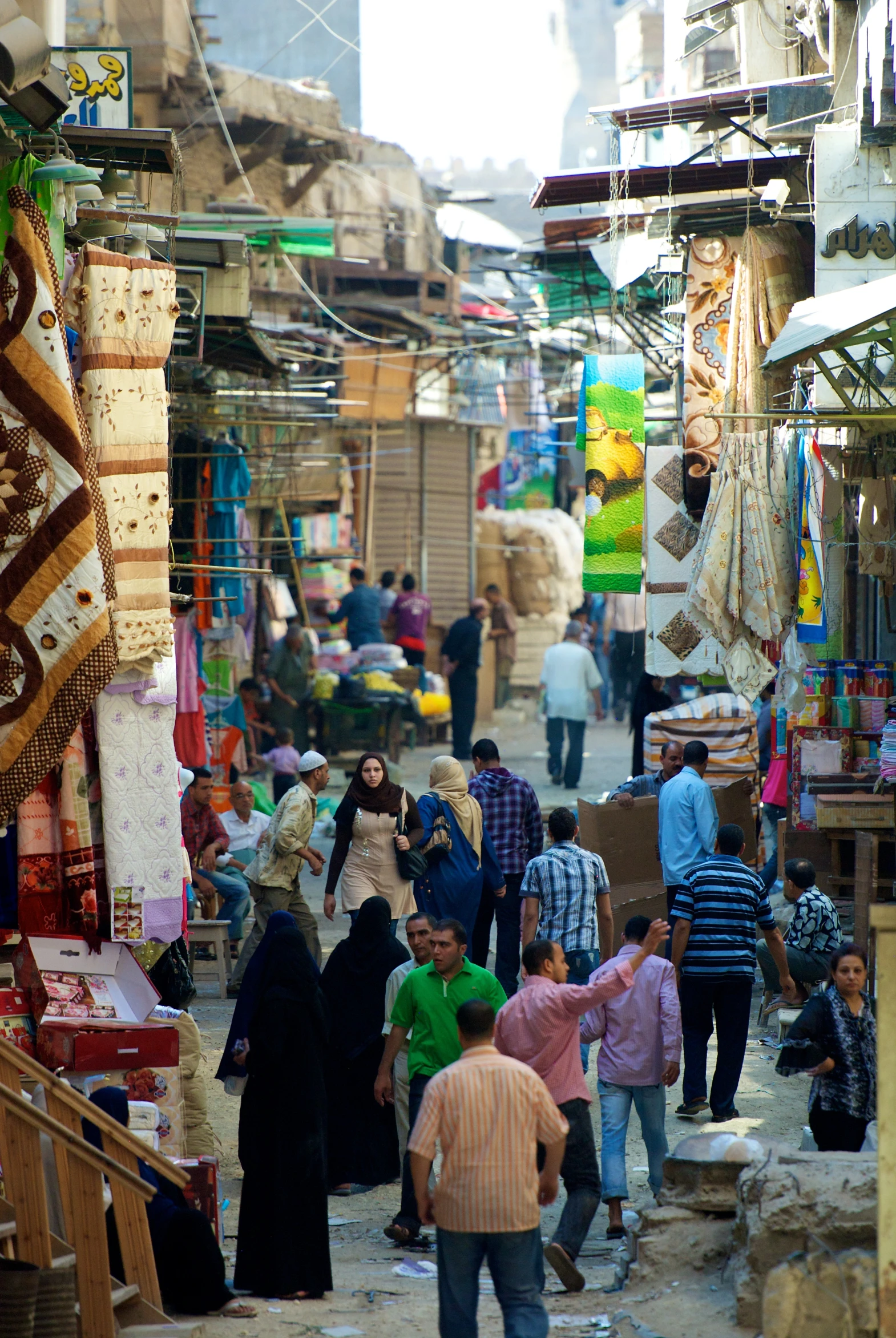 group of people walking down a very crowded street