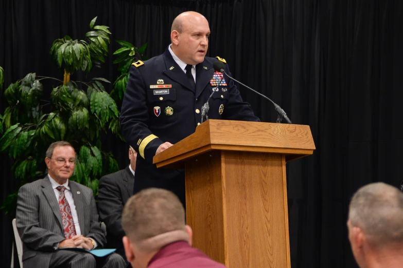 an army general is standing in front of a lectern