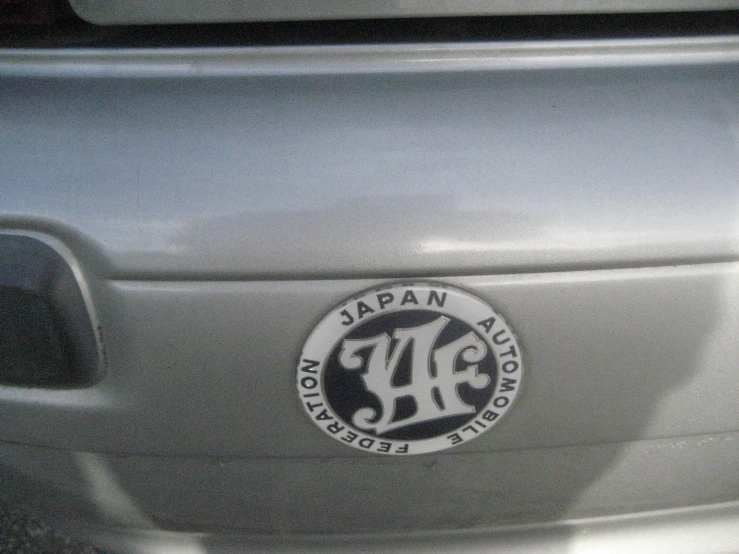 a close up of the side of a car with a japan automobile logo on it
