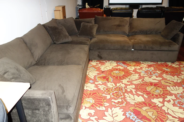 this is a large sectional couch in a room
