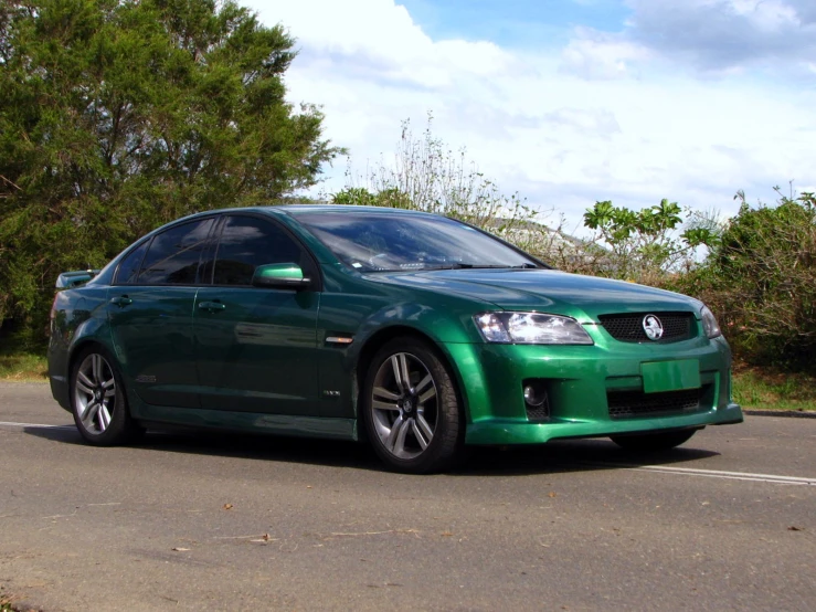 a green car parked on the side of the road