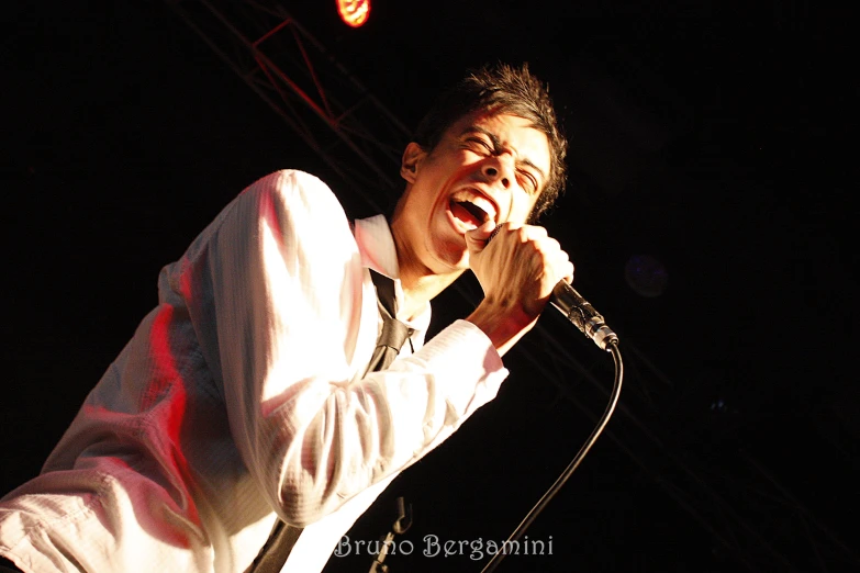 an image of a man singing into a microphone