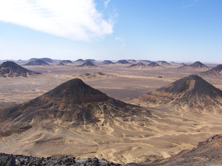 a range of mountains surrounded by desert land