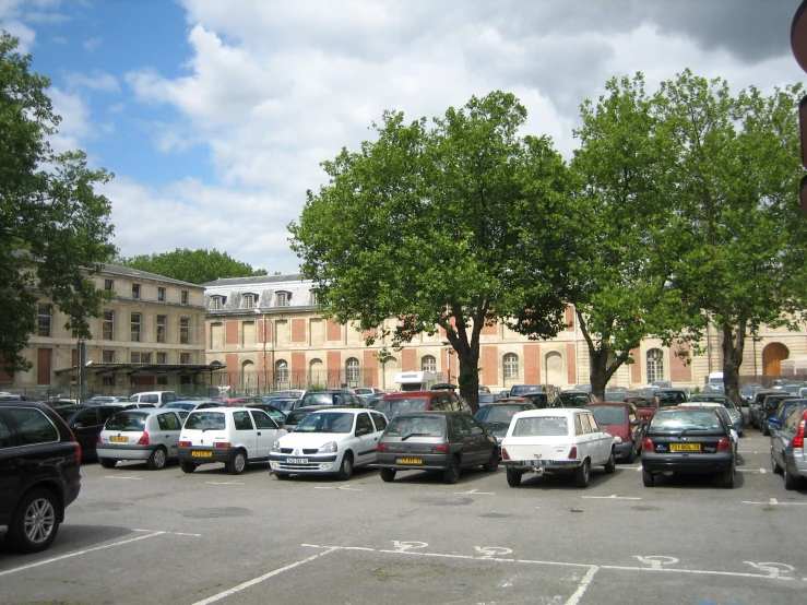 a lot of cars parked on the side of a street