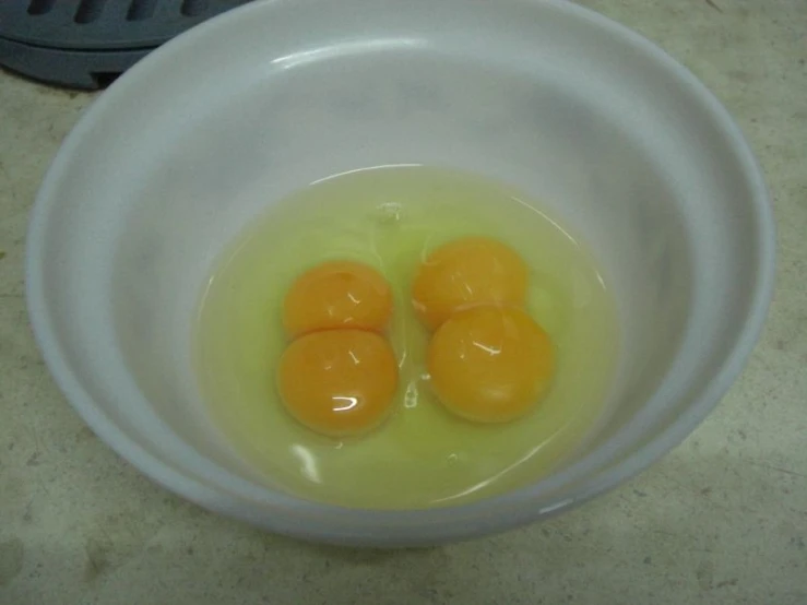 a bowl with three eggs and four ones in it
