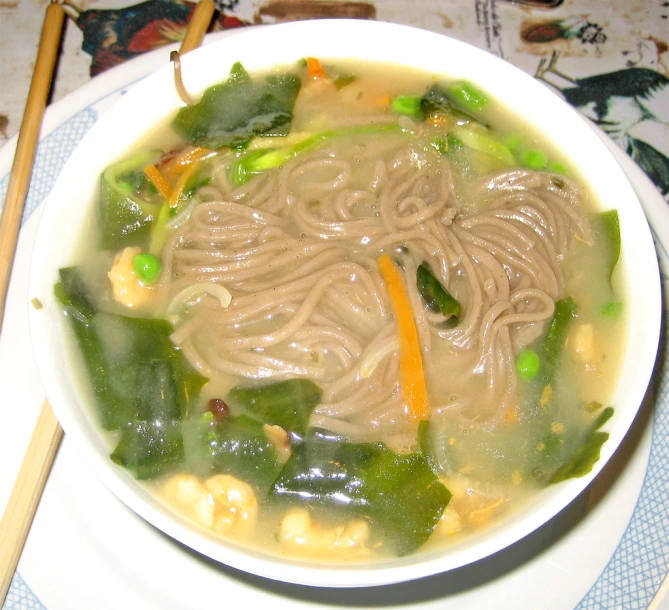 bowl of food on table with chopsticks next to it