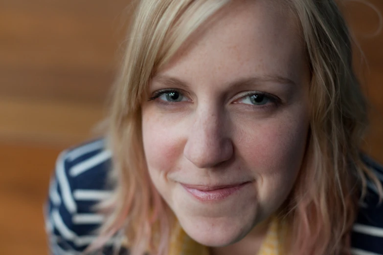 a woman with blonde hair smiling at the camera