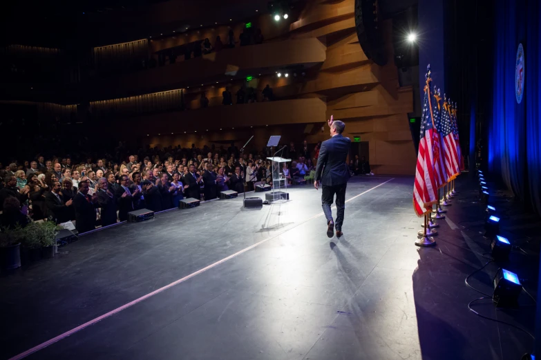 man on the runway holding an american flag