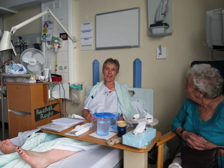 woman having treatment in hospital room with elderly woman