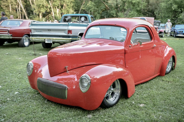 a red car parked on top of grass