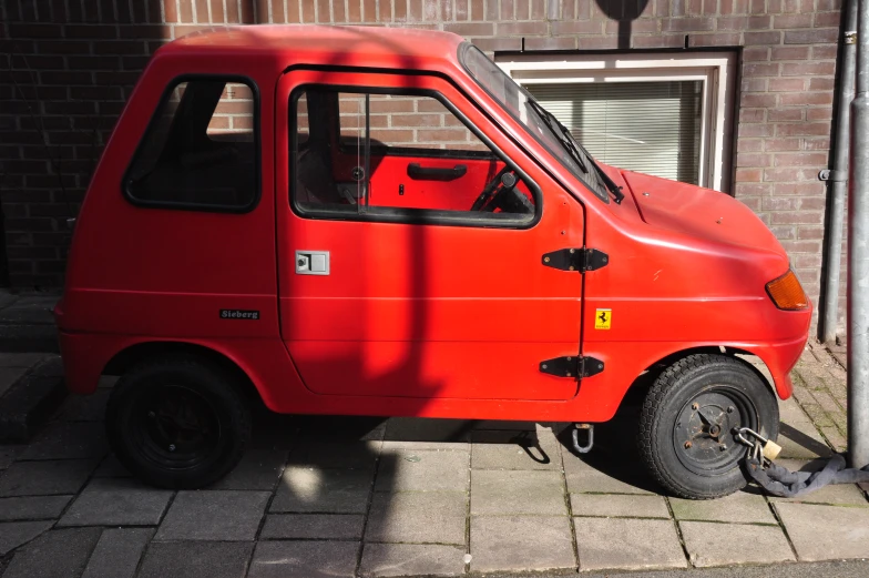 an old red car is parked by a street light