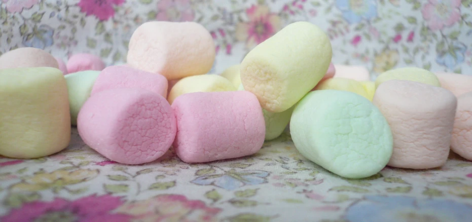 colorful marshmallows are scattered around an up close s