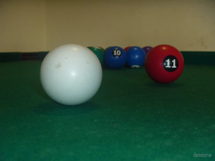 billiards balls line up against each other on the green surface