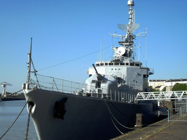 a large naval ship at the port in the water