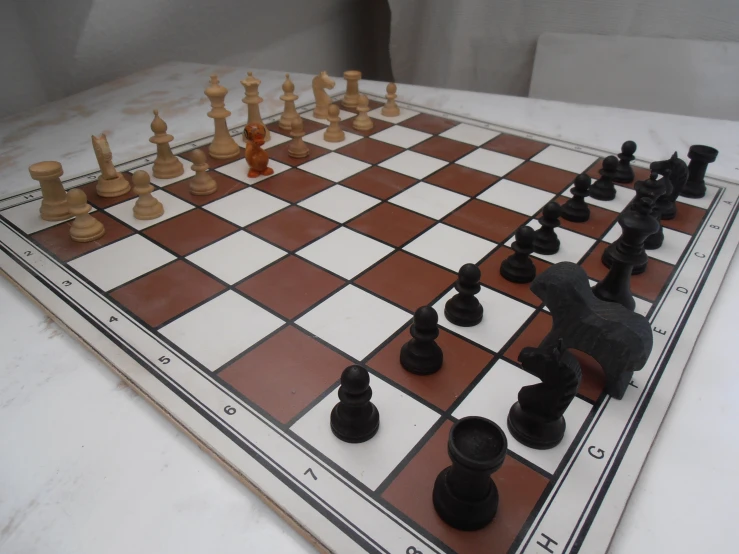an old chess set and its board is displayed