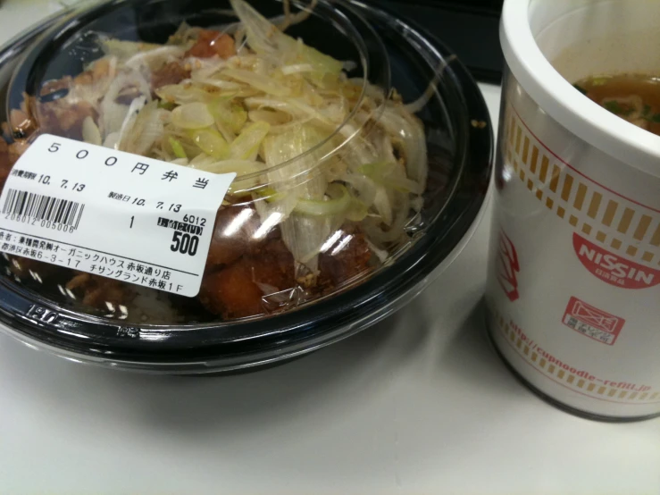 a bowl of food and a plastic cup