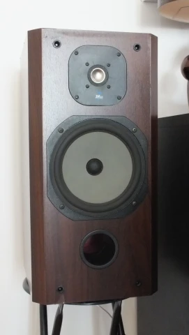 a very tall brown speaker on a stand