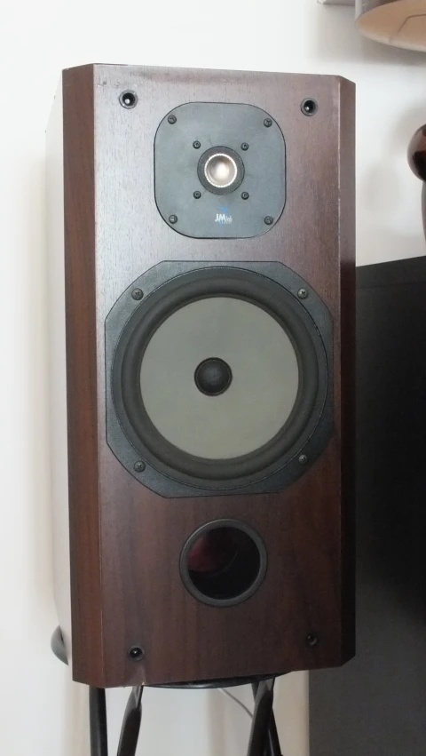 a very tall brown speaker on a stand