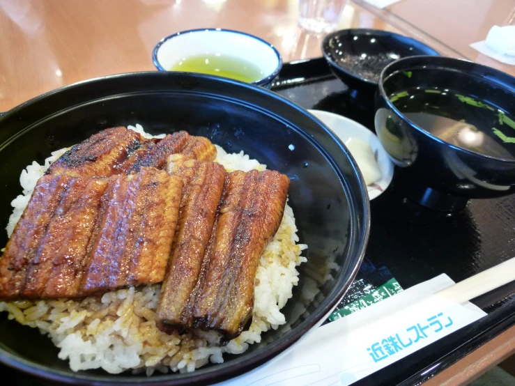 a close up of a plate with rice and meat