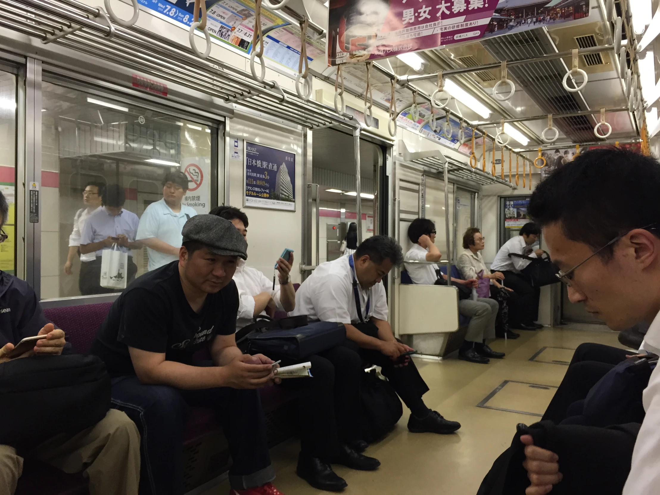 the people are sitting together in the subway