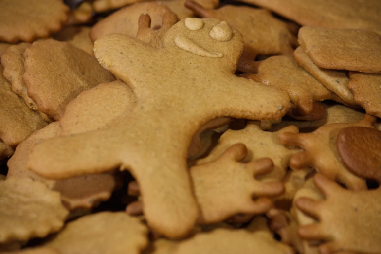 a bunch of cookies with nuts are stacked on a table