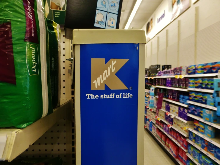 a kiosk with the k logo on it in a store