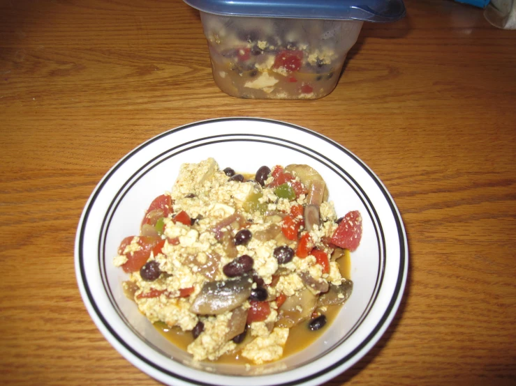 a dish with food on it sitting in front of a bowl