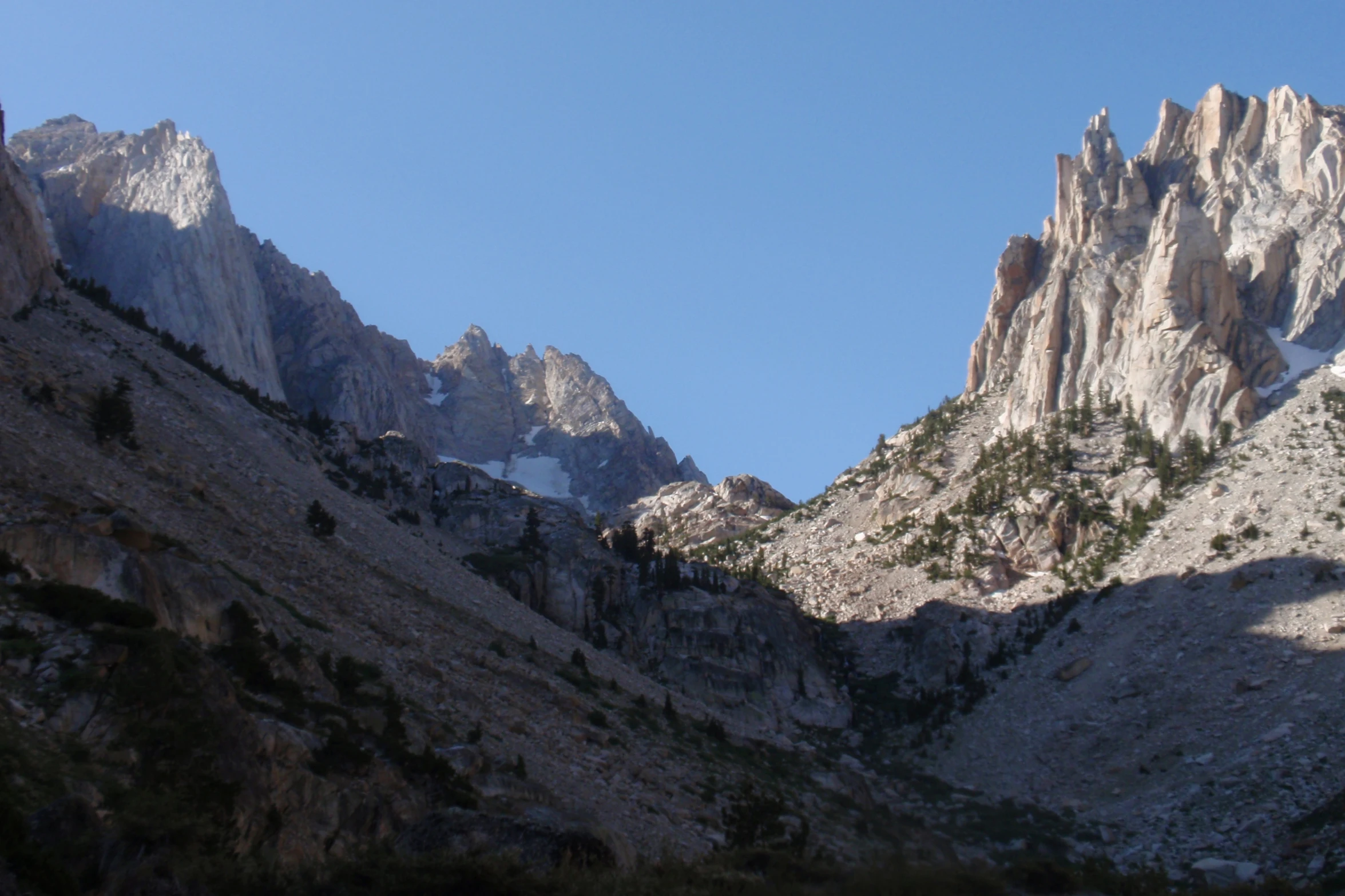 a very tall mountains towering over a mountain side