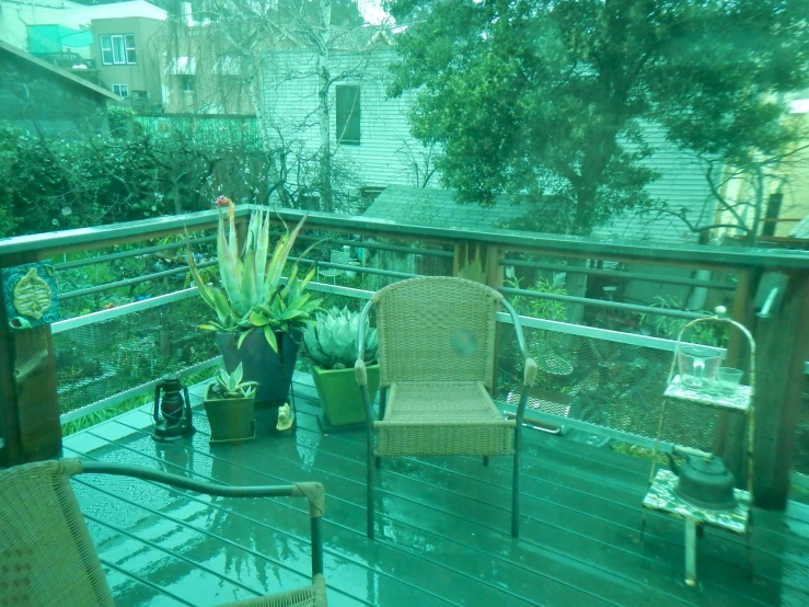 some wicker chairs on a wooden deck outside