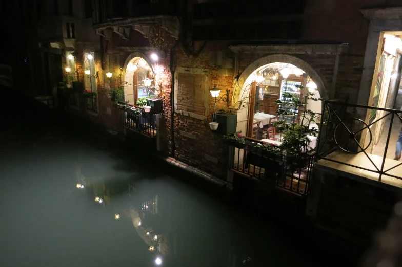 a houseboat on the canal with outdoor seating at night