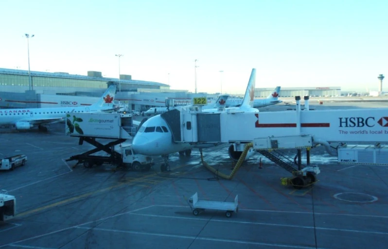 a white plane parked on top of an airport tarmac