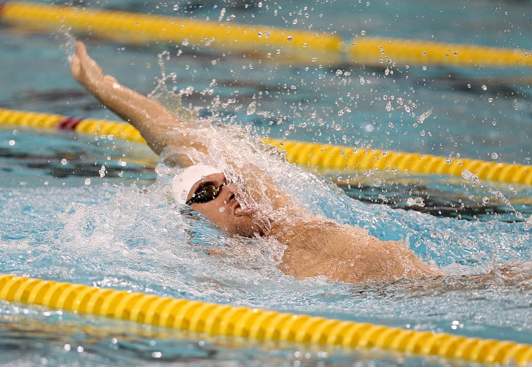 a swimmer is in the middle of her race