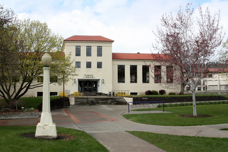 the front entrance of a large white building