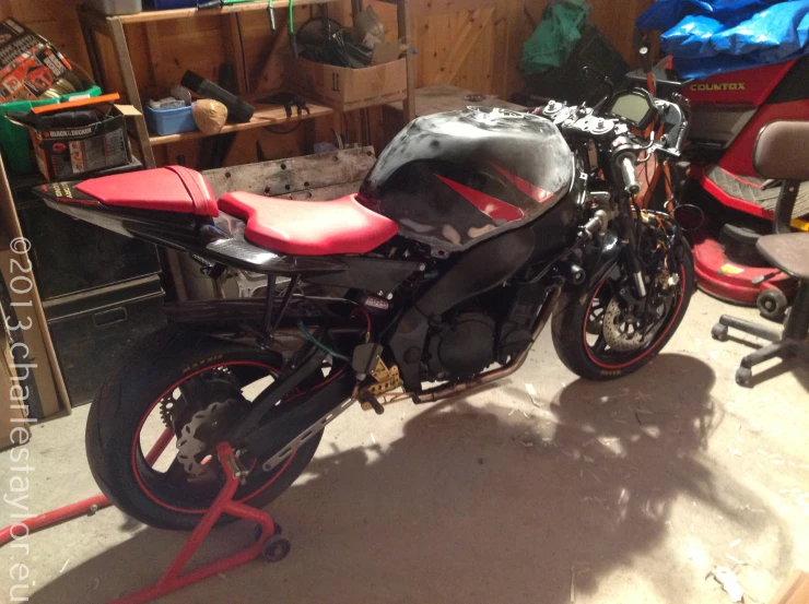 a black motorcycle parked inside of a garage