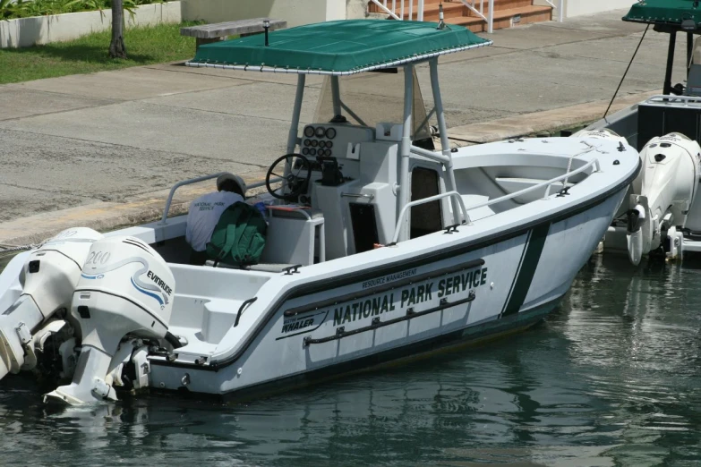 three small white motor boats next to each other