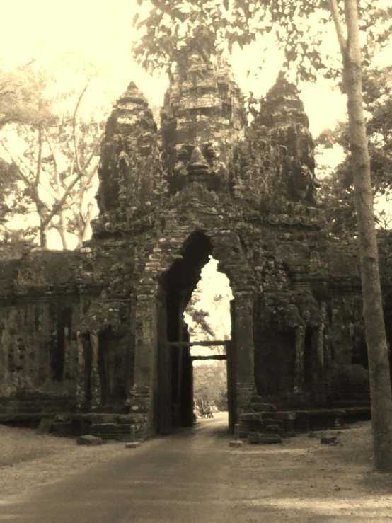 an old gated stone building in the park