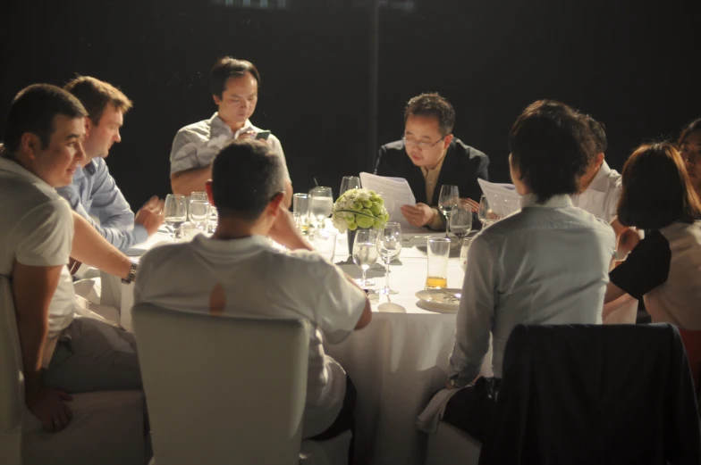 a large group of people sitting around a table